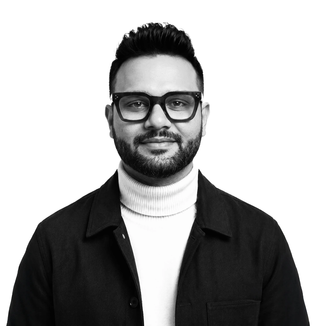 Lokesh Mohan, photographed in black and white: dark-rimmed glasses, a white roll-neck and a black overshirt, looking straight at the camera