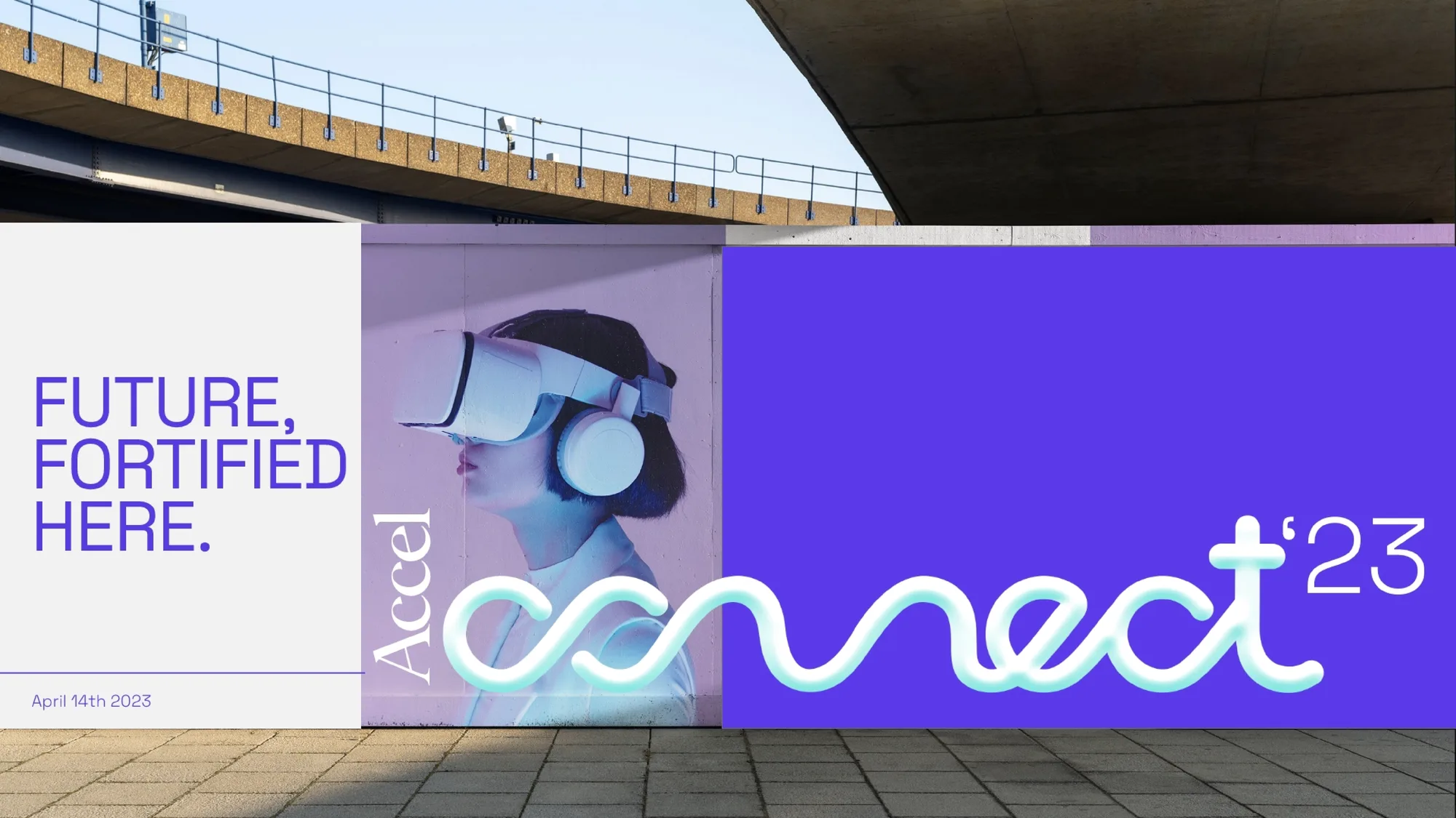Accel Connect wall banner reading ‘Future, fortified here’ beside a VR-headset ad, installed under a highway overpass