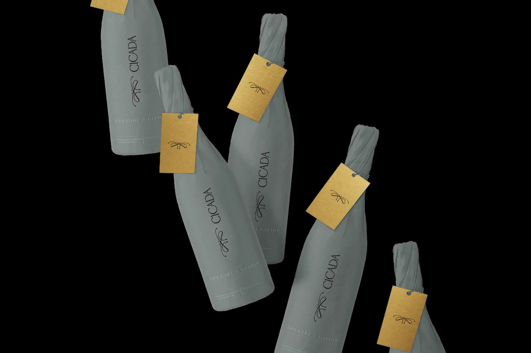 Special-edition Cicada bottles wrapped in grey fabric with gold-foil hang tags carrying the emblem